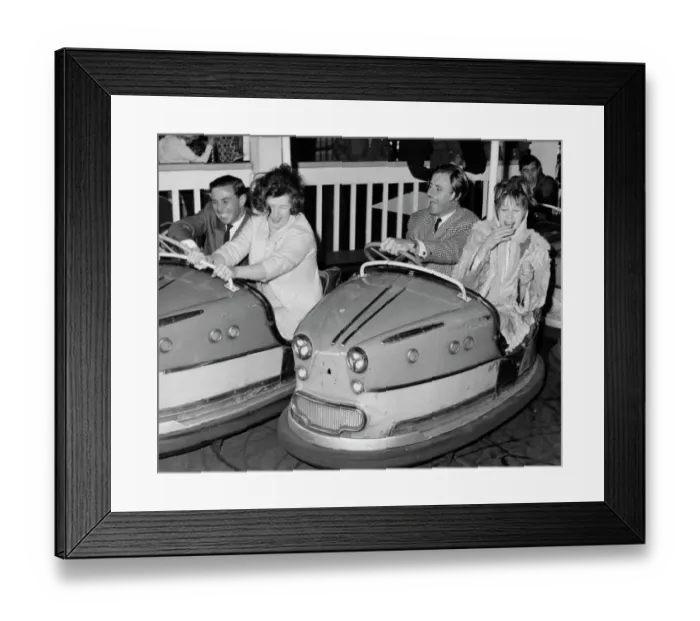 Framed Print : Racing drivers Graham Hill and Jim Clark enjoying a dodgem ride