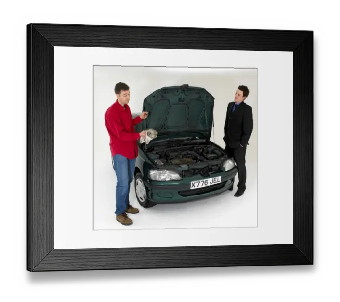 Framed Print : Car salesman with customer checking oil levels Framed Print : Car salesman with customer checking oil levels