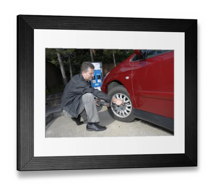 Framed Print : Man inflating car Framed Print : Man inflating car