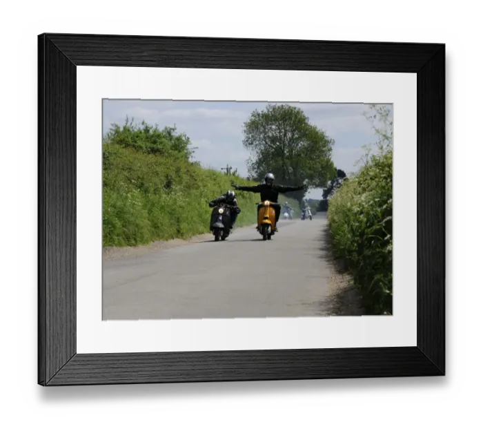 Framed Print : High Spirited scooter riders on a run