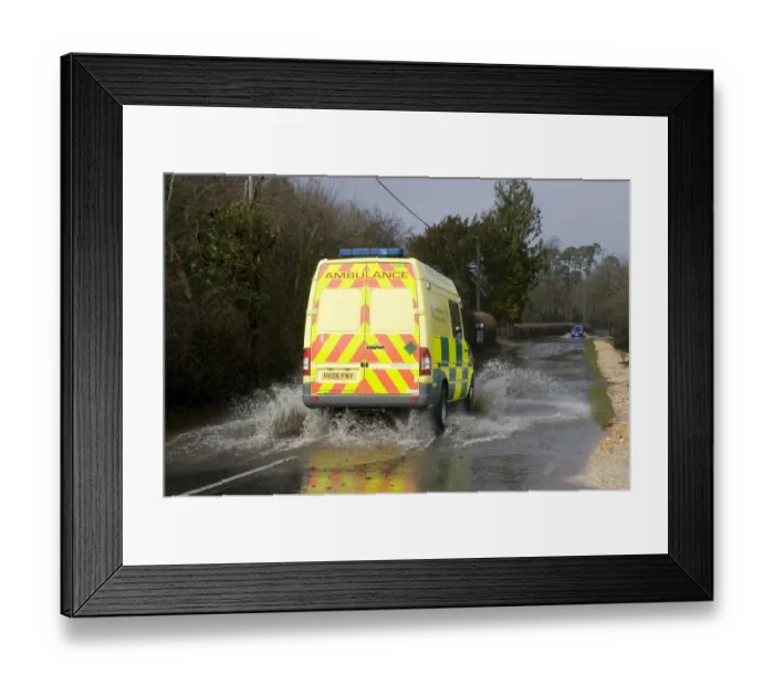 Framed Print : Ambulance driving on flooded road