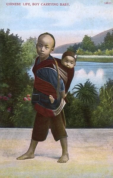 Chinese boy carrying his younger sibling on his back
