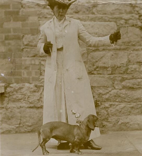 Edwardian woman with a dachshund on a lead
