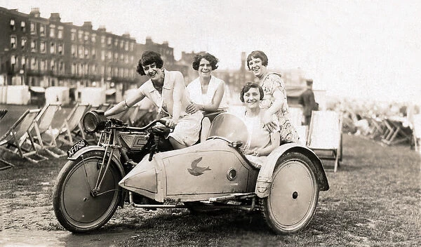 Four Ladies sitting on a 1920 New Gerrard motorcycle & sidec