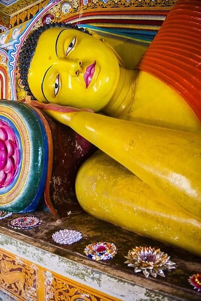Colourful reclining Buddha statue at Isurumuniya Vihara, Anuradhapura, UNESCO World Heritage Site, Sri Lanka, Asia