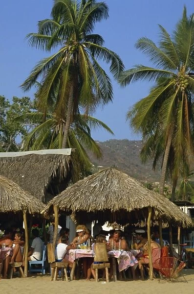 Tourists at a cafe on the beach at Acapulco