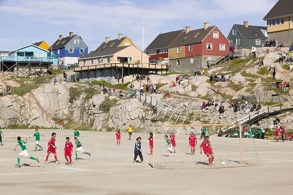 A football match in Ilulissat on Greenland. Ilulissat is a UNESCO World Heritage Site because of the Jacobshavn Glacier or Sermeq Kujalleq which is the largest glacier outside Antarctica. The glacier drains 7% of the Greenland ice sheet and