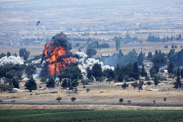 An explosion is seen at Quneitra at the Syrian side of the Israeli Syrian border as it is