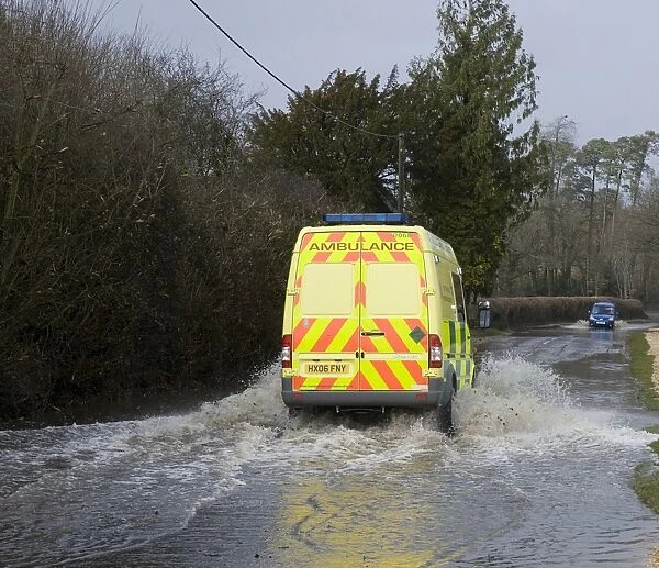 Ambulance driving on flooded road