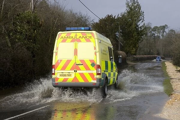Ambulance driving on flooded road