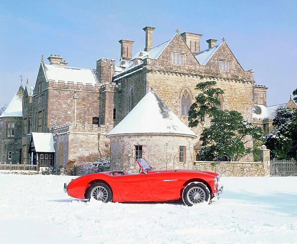 Austin Healey 100 in snow in front of Palace House