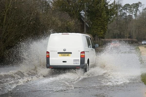 Van splashing through flood