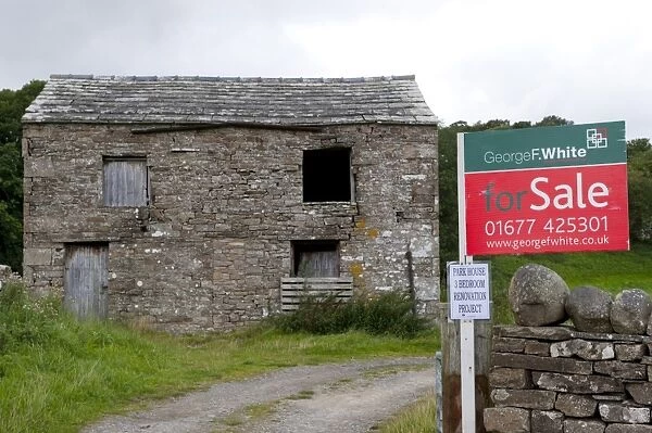 Rural farm barn with planning permission, with For Sale sign outside, North Yorkshire, England, august