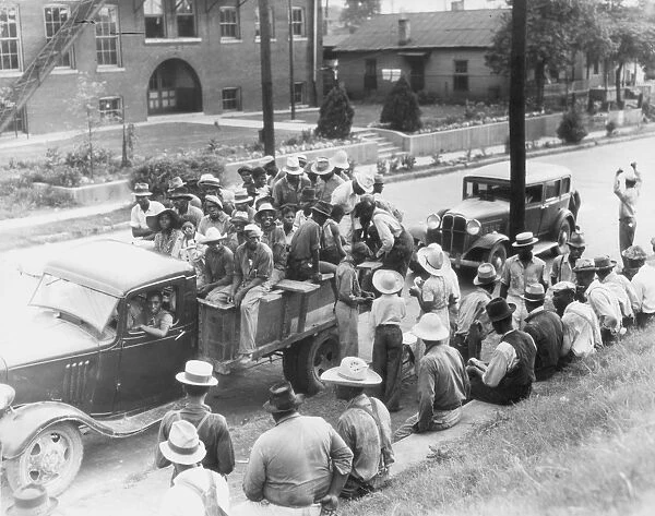 COTTON PICKERS, 1937. Cotton hoers in Memphis, Tennessee, preparing to depart for