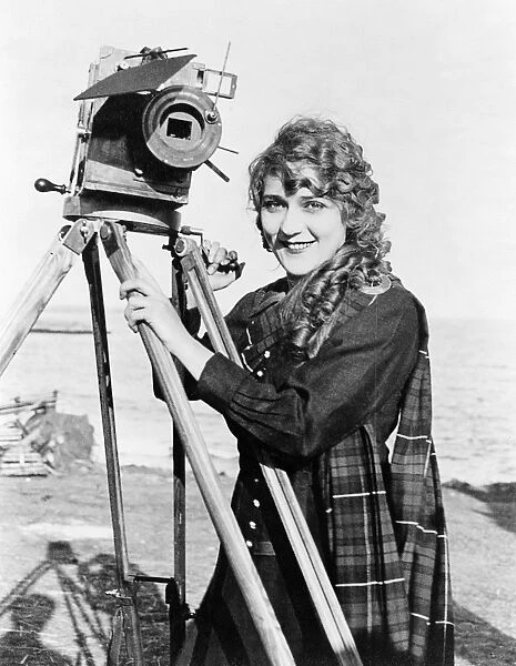 MARY PICKFORD (1893-1979). Born Gladys Mary Smith. American actress, with a movie camera on a beach