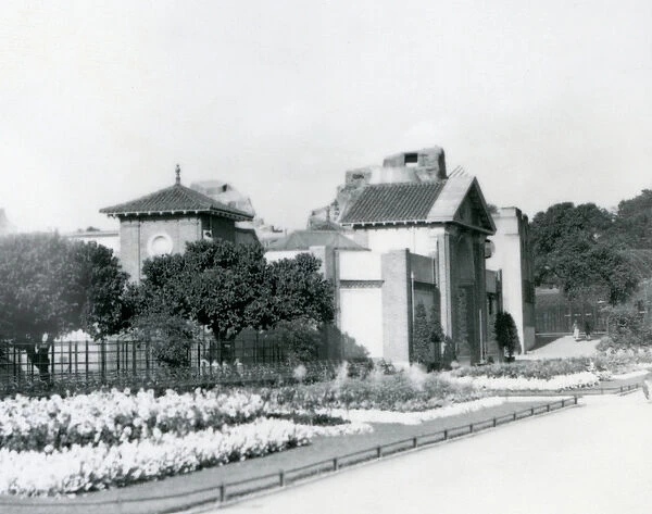 The Reptile House at London Zoo in 1928 with formal flower beds along the paths to