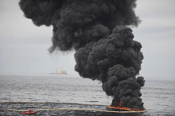 Gathered concentrated oil burns during a controlled oil fire in the Gulf of Mexico