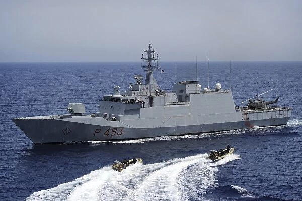 An Italian visit, board, search and seizure team returns to the Italian navy offshore