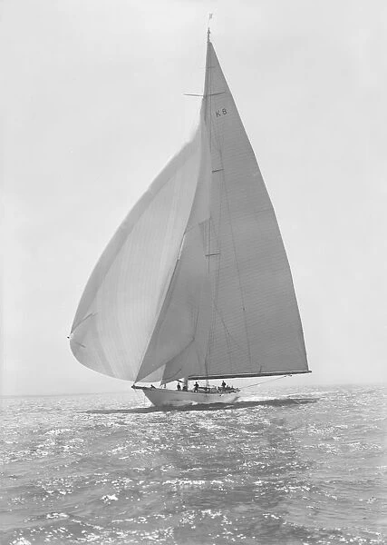 The 23 Metre Candida (K8) sailing with spinnaker, 1935. Creator: Kirk & Sons of Cowes
