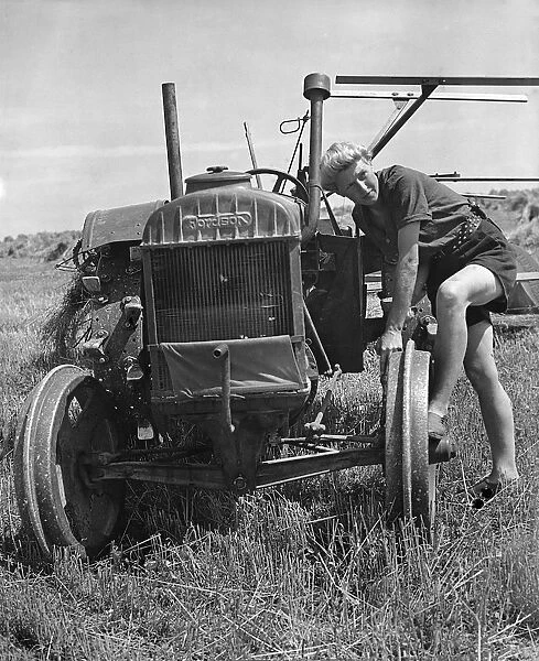 Fordson tractor, with Land girl 1940 s. Creator: Unknown