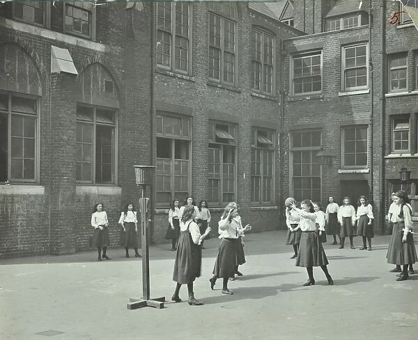 Girls playing netball in the playground, William Street Girls School, London, 1908