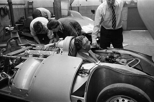 Men, including Syd Enever and Tommy Wisdom looking at the MG EX181 which is being worked