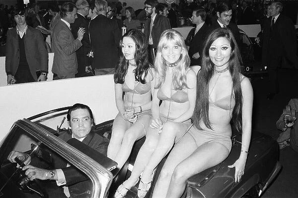 Models are driven to their stand at the 1971 Earls Court motor show 19th October 1971