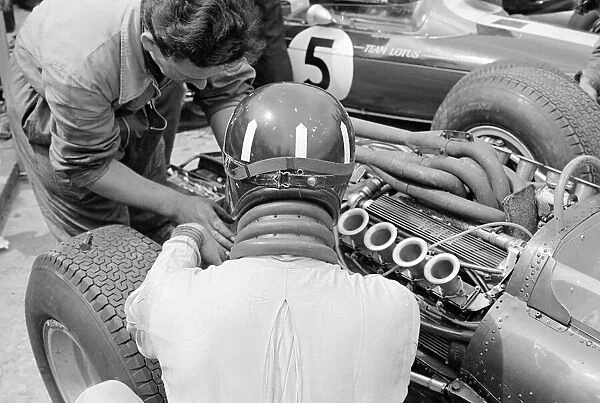 Silverstone Practice Day- Graham Hill in the pits with his BRM mechanic. July 1965