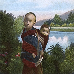 Chinese boy carrying his younger sibling on his back