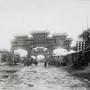 Gate and street, likely Peking, Beijing, China