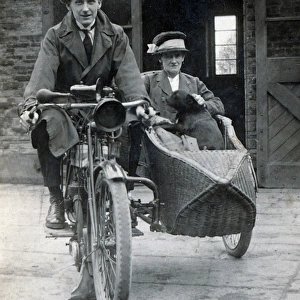 Gentleman & lady on a 1910 Triumph motorcycle & sidecar