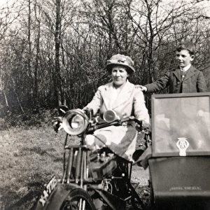 Lady on 1920 Royal Enfield motorcycle combination with boy