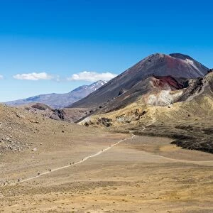 Hikers are dwarfed by the volcanic Mount Ngauruhoe on the Tongariro Crossing trail