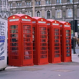 A line of four red telephone boxes at Charing Cross, London, England, United Kingdom