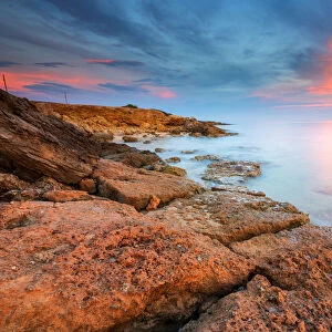 Rocks on the Salento coast at sunset, Dunes of Campomarino, Taranto province, Apulia