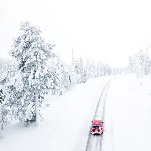 Elevated view of car along the snowy road in the icy forest, Pallas-Yllastunturi
