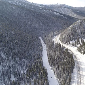 A car drives along the R257 federal highway in the Western Sayan Mountains in Krasnoyarsk