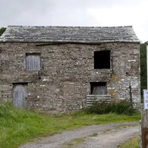 Rural farm barn with planning permission, with For Sale sign outside, North Yorkshire, England, august