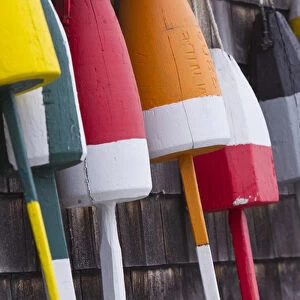 Colorful lobster buoys hang from harbor deck in Bernard, Maine, USA