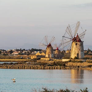Italy, Sicily, Trapani Province, Marsala. Wind mills at the salt evaporation ponds in the