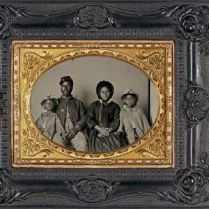 CIVIL WAR: FAMILY, c1864. Portrait of a Union soldier with his wife and daughters