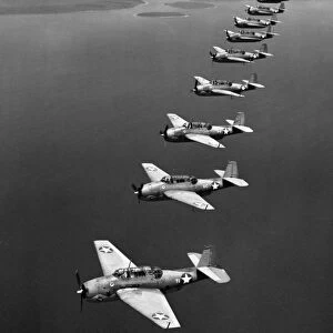 A flight of twelve Grumman Avenger torpedo-bombers over the South Pacific, 1943, during World War II