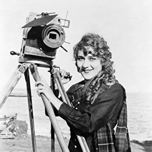 MARY PICKFORD (1893-1979). Born Gladys Mary Smith. American actress, with a movie camera on a beach