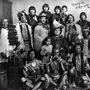 PUEBLO GROUP, 1904. A group of Pueblo Native Americans, three holding a snake in the foreground, with two white American men in the center. Photographed at the Worlds Fair in St. Louis, Missouri, 1904