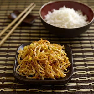 Marinated bean sprout salad served with bowl of white rice, chopsticks, traditionally Korean