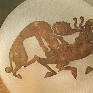 Ornament depicting a tiger tearing a moose