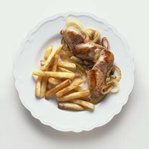 Plate of Andouillettes, veal sausages, served with French fries and fried onions, a typical dish from Lyon, France, view from above