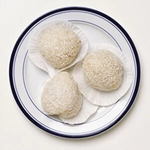 Three sticky rice scoops on a plate