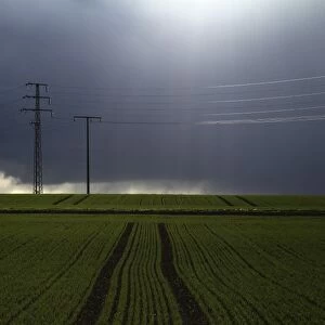 Stormy sky over fields with electricity pylons, Biberach, Upper Swabia, Baden-Wuerttemberg, Germany