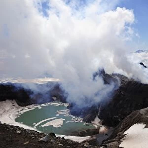Volcanic crater with crater lake and a hot water vapour cloud, Gorely volcano, Kamchatka Peninsula, Russia